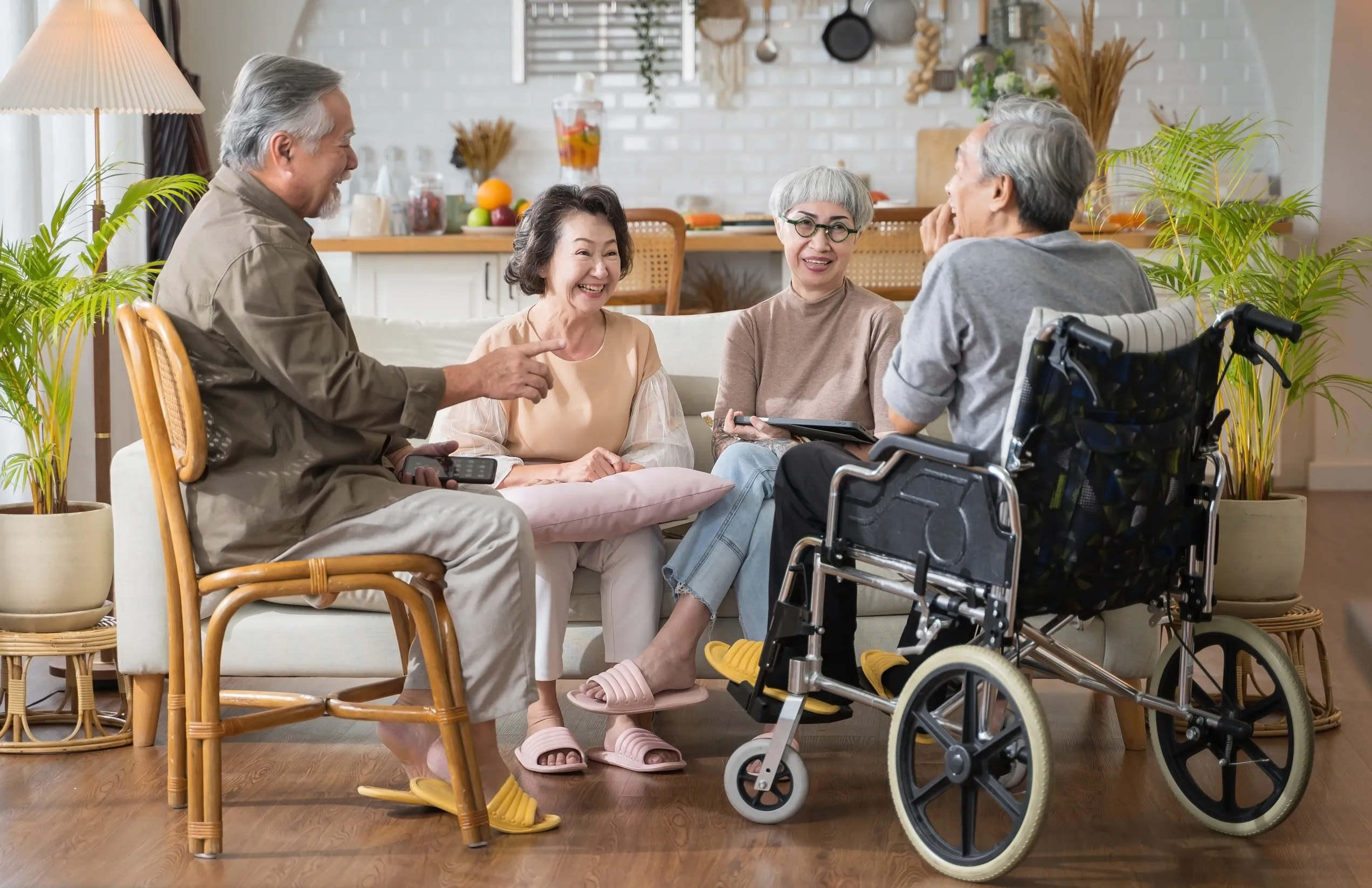 Group Asian seniors friends are sitting in the living room of a home together, enjoying talking together